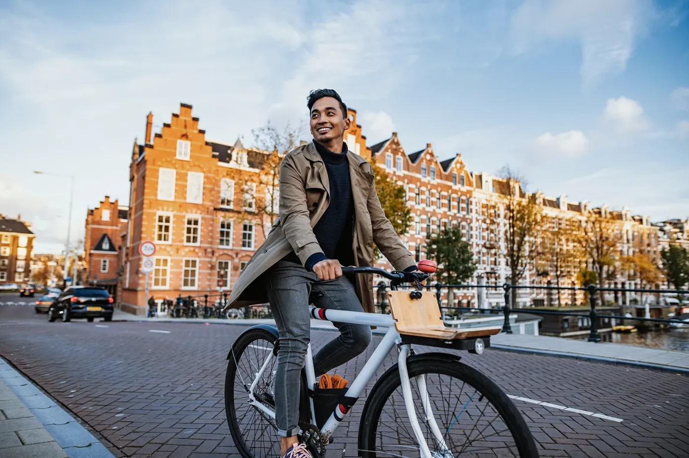 Young man riding a bicycle through a European city street