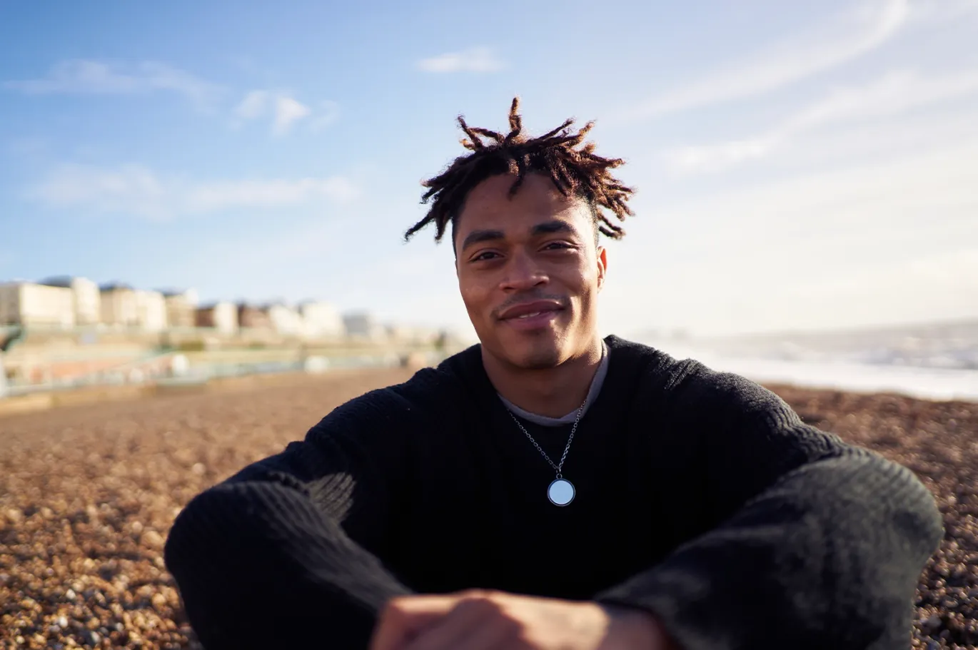 Young man relaxing outdoors near a scenic waterfront.