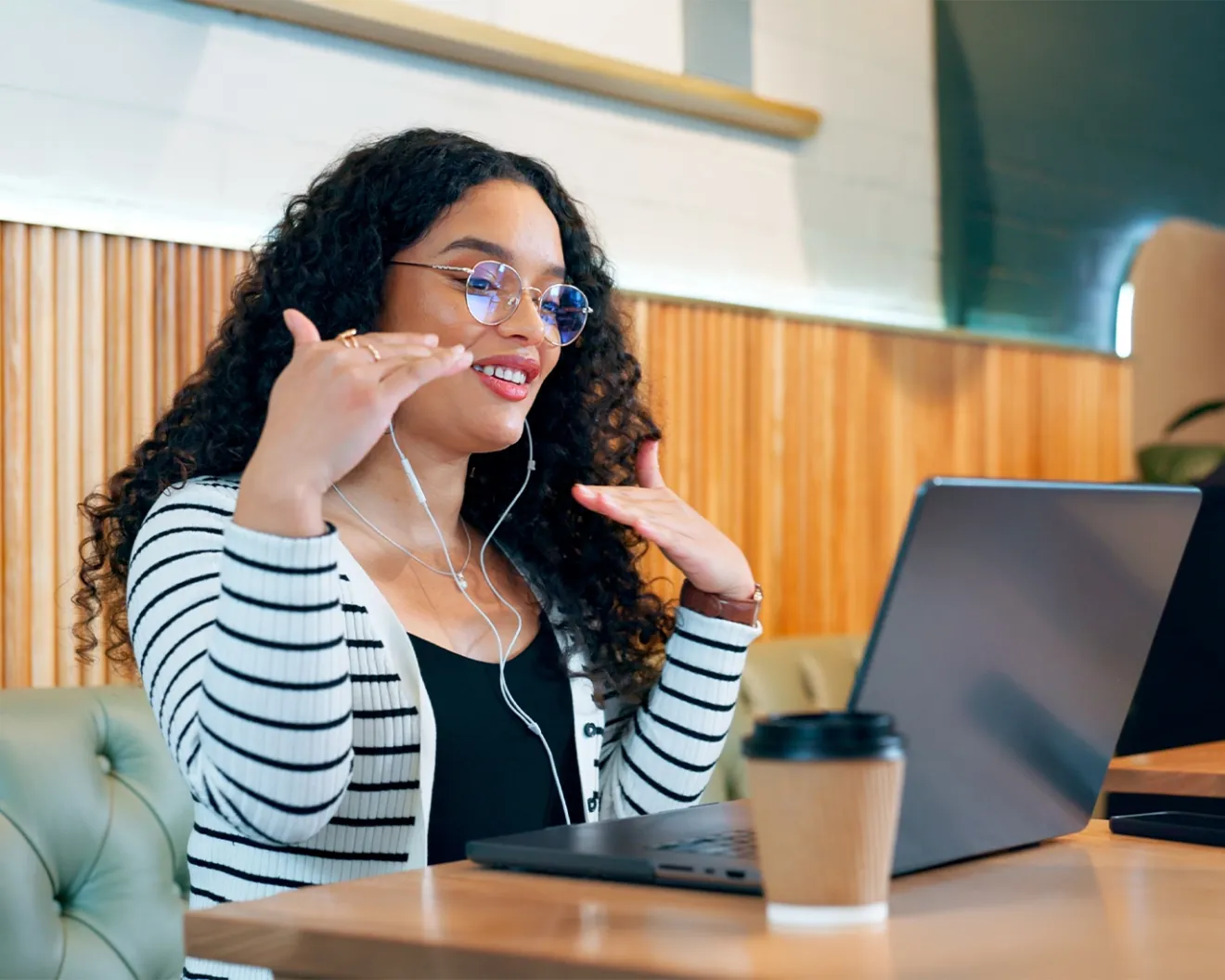 Woman sitting in a coffee shop with her laptop