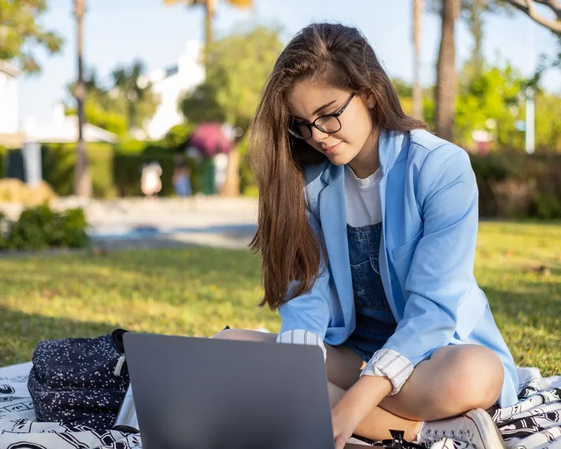 young-woman-online-ielts-study-outdoors